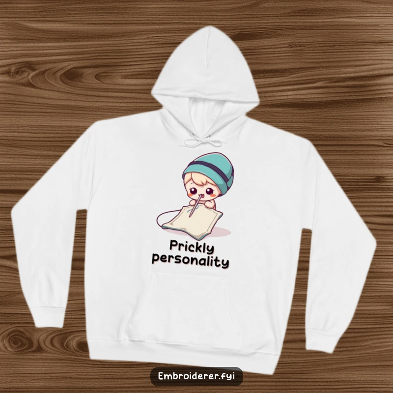Funny Needle Hoodie featuring a playful needle making small, mischievous jabs at a scrap of fabric, bringing cozy humor.