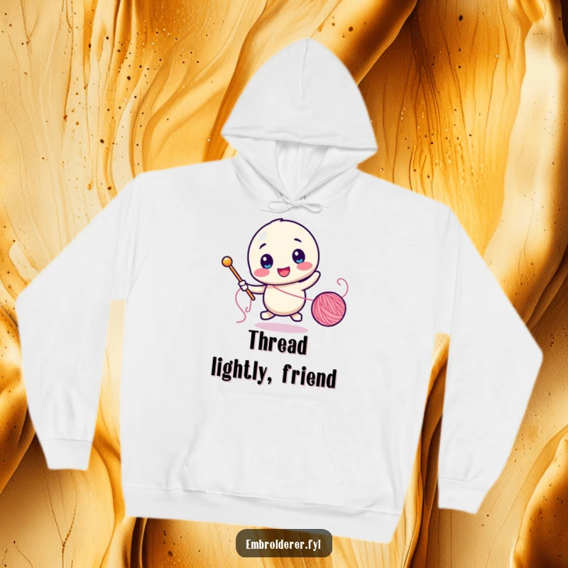 Funny hoodie featuring a character comically pursuing a rolling spool of thread with a sewing needle.