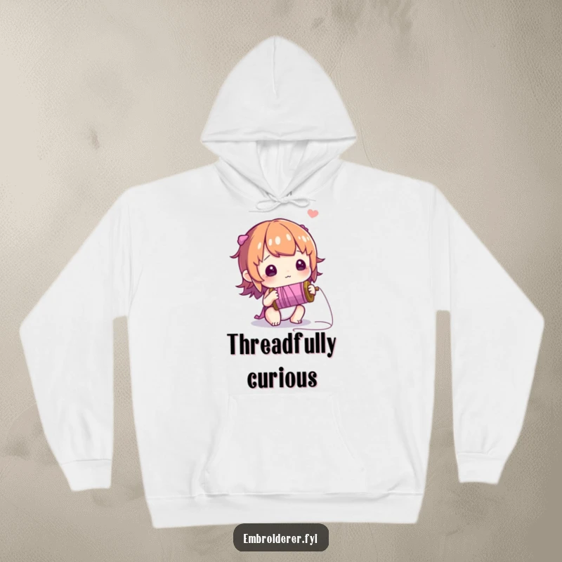 Funny hoodie showing a curious character filled with wonder while examining a spool of thread, celebrating creative discovery.