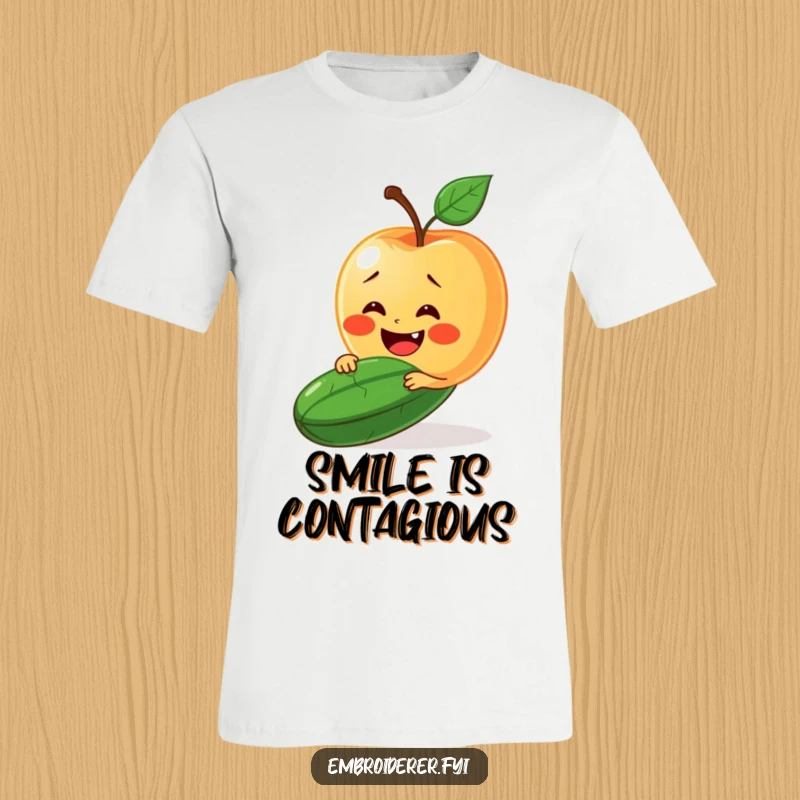 Funny t-shirt featuring a happy apple trying to stitch a smile onto a grumpy cucumber.