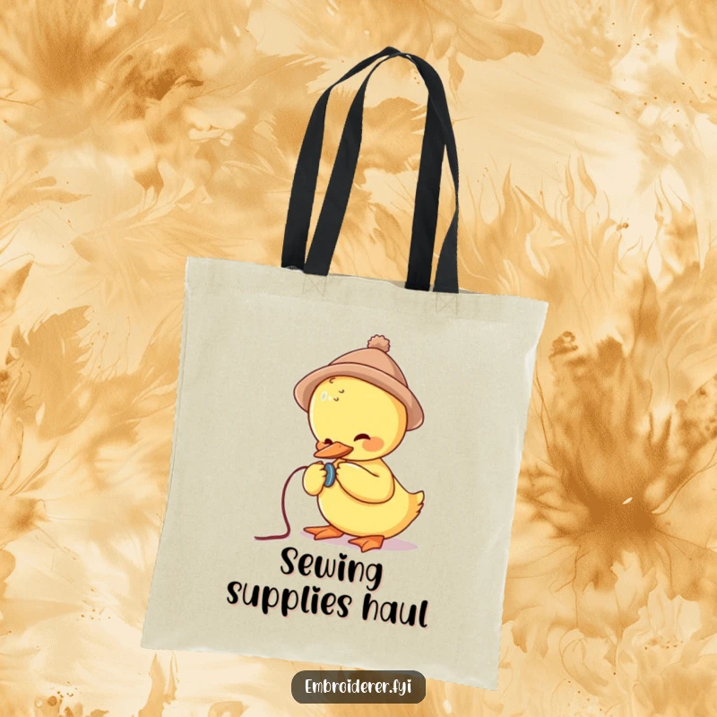 Funny tote bag featuring a cute duck in a tiny hat struggling to sew a button, promoting sewing and crafting themes.