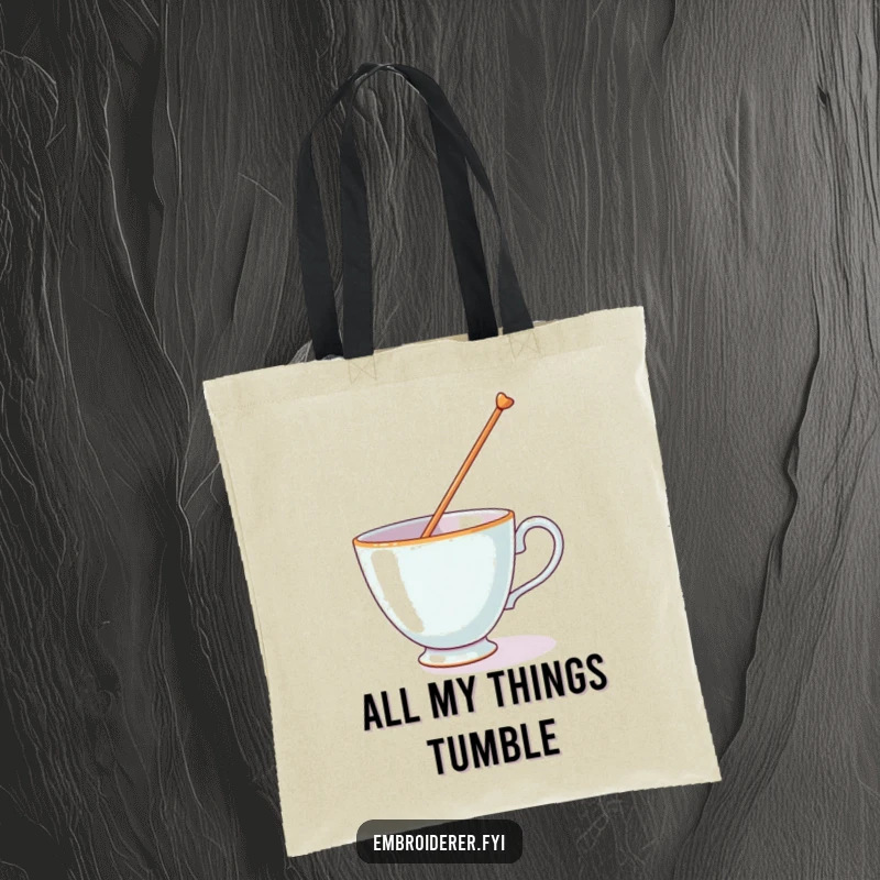 Funny tote bag with a teacup trying to balance a huge needle, highlighting a comical and stressful moment.